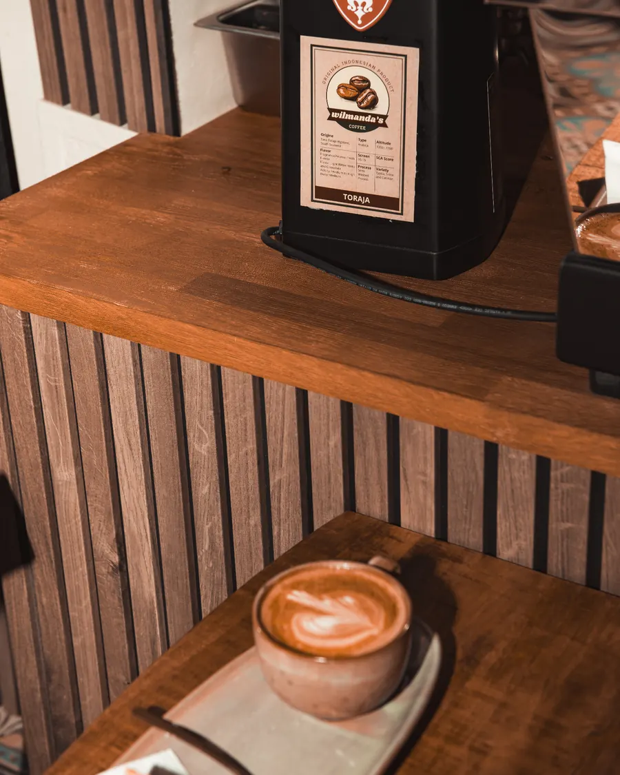 Espresso pouring into a cup on the machine's group head
